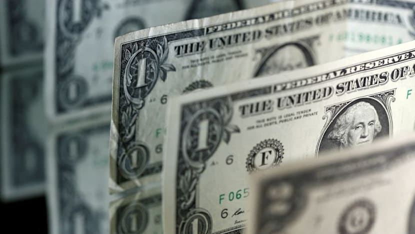 Dollar holds losses as risk appetite flickers ahead of central bank meetings