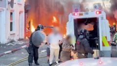 Watch: Residents flee as cars and houses burn in Belfast